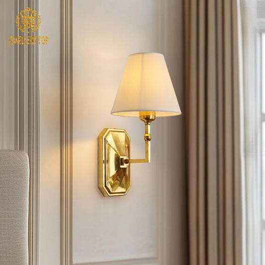 Close-up front view of the classical brass sconce showcasing its octagonal backplate and pleated lampshade.