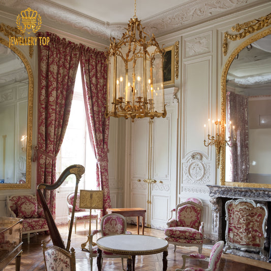 JEWELLERY TOP French brass pendant light installed in a classic room with mirrors and pink chairs.