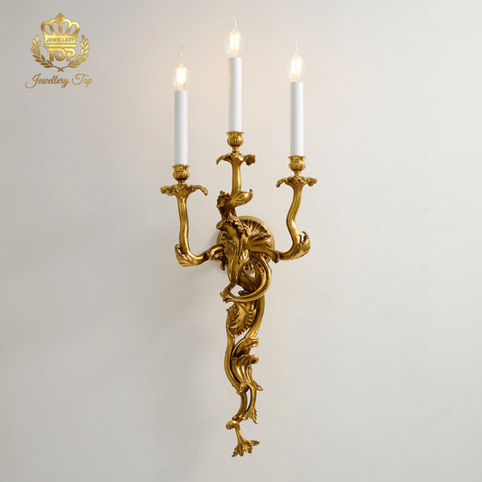 Front view of The Chloris 3-light Rococo sconce in polished solid brass by Jewellery Top.