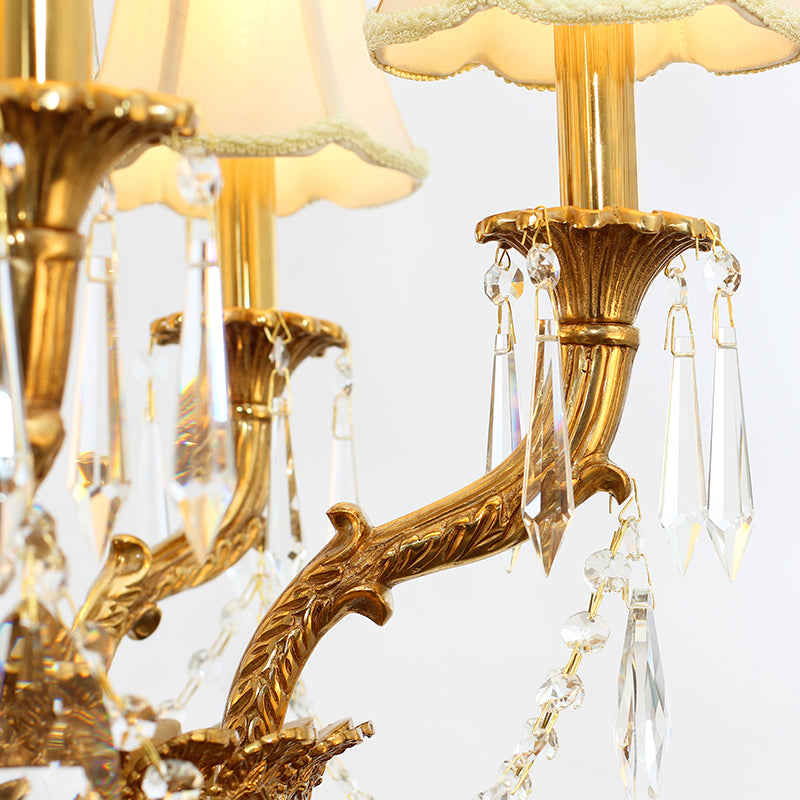 Detailed shot of intricate brass scrollwork and delicate K9 crystal droplets on the chandelier.