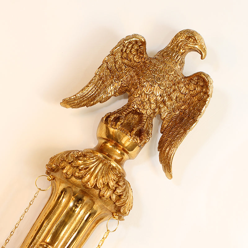 Side profile of the eagle wall light installed, showcasing its projection and the decorative flow of its hanging elements.