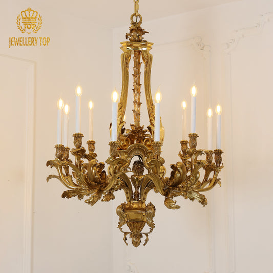 Front view of a hand-carved golden brass chandelier with candle lights, white background.