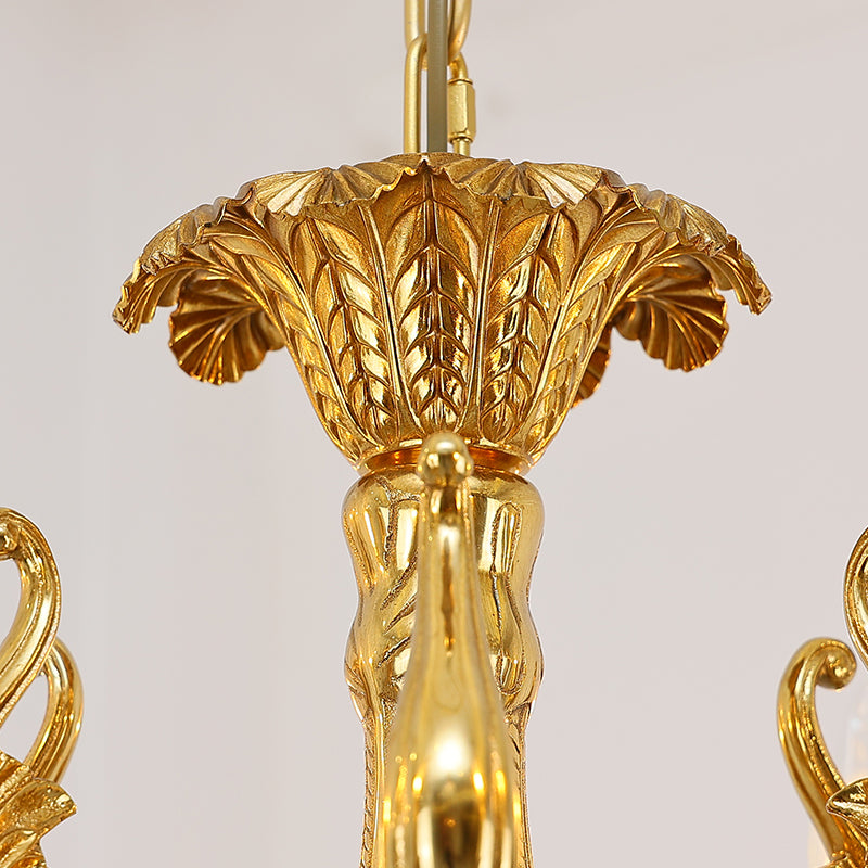 Macro close-up of a hand-carved brass rosette and a faceted crystal droplet.
