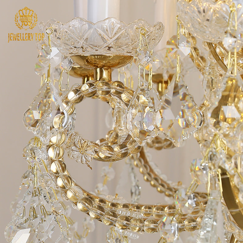 Detailed view of intricate brass rings and crystal bead strings on a luxury chandelier.