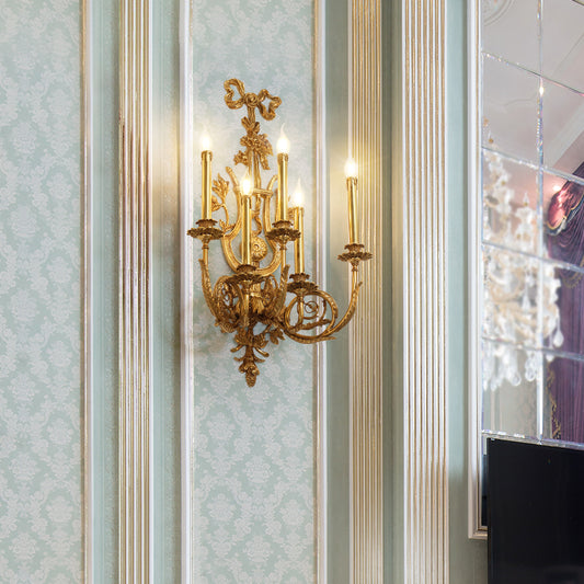 The French luxury wall lamp with three candle lights installed on a light blue and white damask wallpaper.