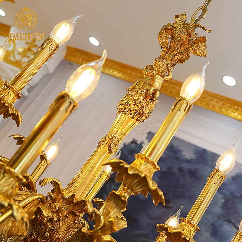 Low-angle view of a multi-arm brass chandelier with angel sculptures and gold trim.