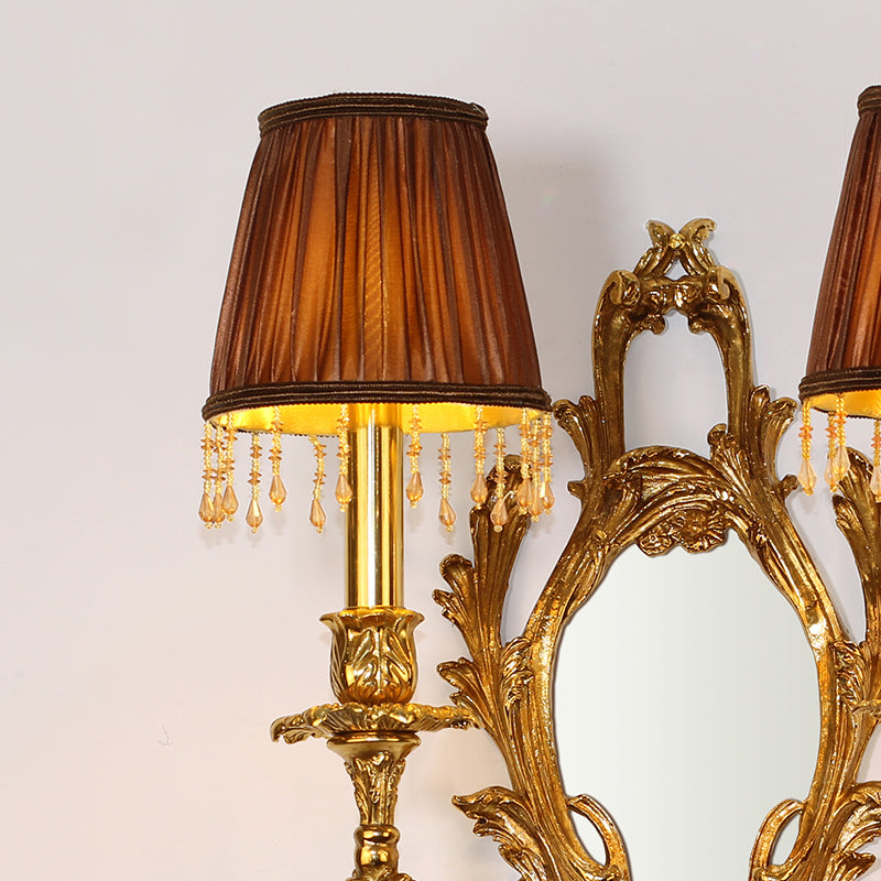 A pair of the fabric lampshade wall lamps installed on either side of a gilded mirror, demonstrating perfect symmetry.