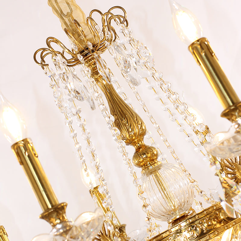 Extreme close-up of a fluted brass arm, a crystal rod, and cascading crystal bead chains.
