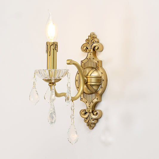 The installed European brass wall lamp on a white wall, emitting a warm glow beside a mirror with auspicious Chinese characters.