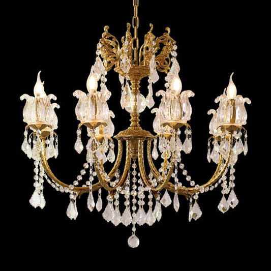 Close-up of a French brass chandelier’s dense crystal fringe and candle-style bulbs on black.