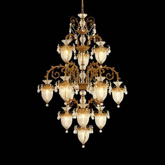 A grand french chandelier installed in a residence with a high ceiling, ornate plaster moldings, and draped curtains.
