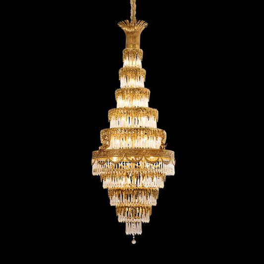 Golden Baroque brass chandelier with layered crystal fringe, isolated on black.