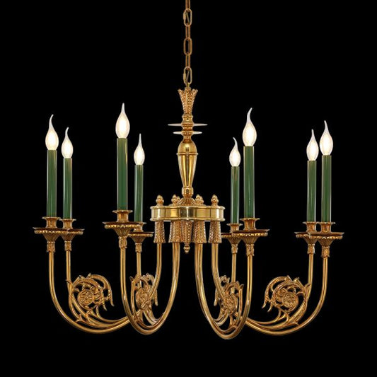 Eight-arm golden brass chandelier with detailed scrollwork and green candles, black background.