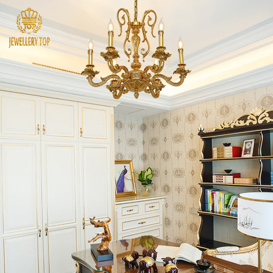 JEWELLERY TOP hand-carved brass chandelier installed in an elegant bedroom with ornate decor.