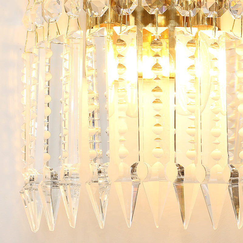A row of the mid-century inspired crystal wall lights installed on a classic paneled hallway wall.