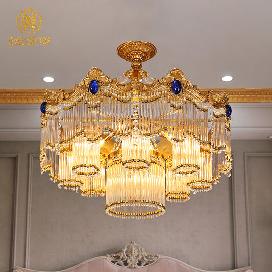A luxurious dining room interior featuring the large circular brass chandelier as the central focal point above an ornate dining set.