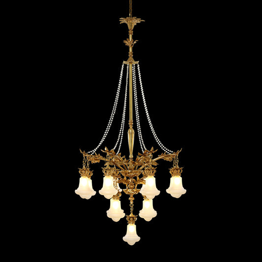 A golden antique brass chandelier with multiple pearl bead curtains, isolated on black.