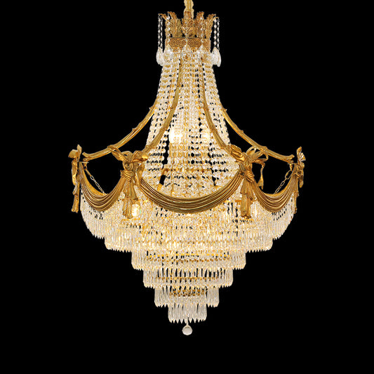 A large size luxury chandelier installed in a grand villa lobby with marble walls and a high ceiling.