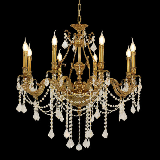 Detailed close-up of a French brass chandelier with intricate arms and crystal droplets.