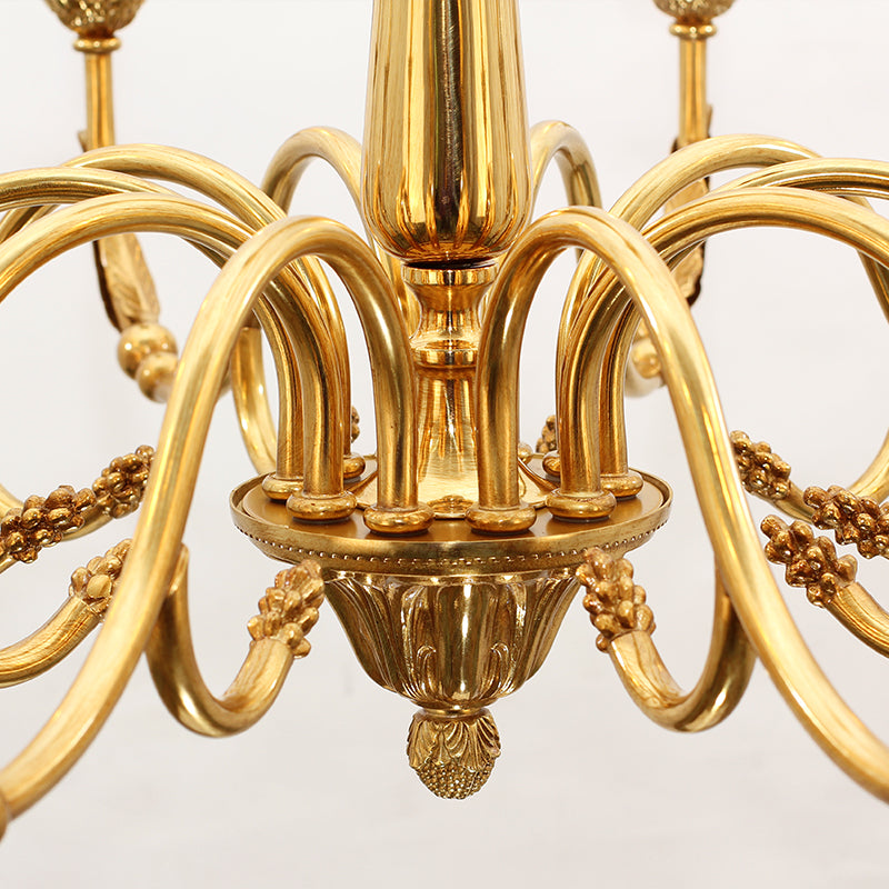 Top-down detailed view of a brass chandelier’s central column and radiating structure.