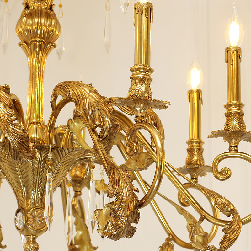 Extreme detail shot of the ornate candle sockets and the interwoven golden metalwork forming the canopy.