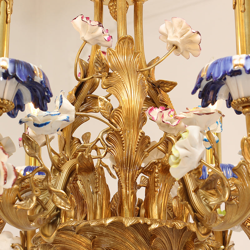 Macro detail of intricate brass scrollwork holding assorted hand-painted porcelain flower shades.