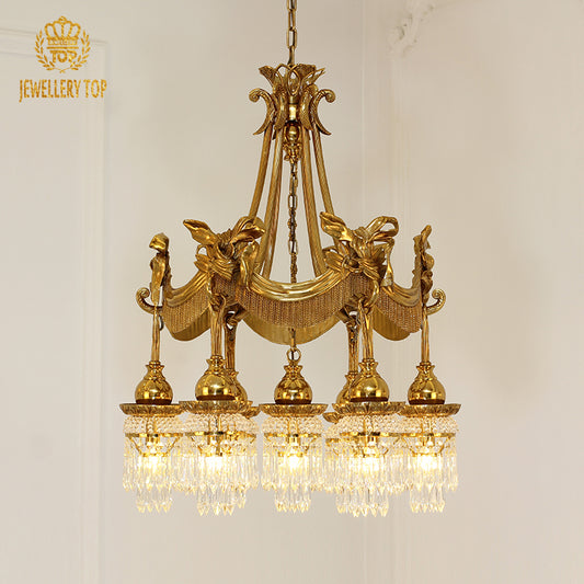 A luxurious living room interior featuring the large multi-tiered brass chandelier hanging below an ornate ceiling medallion.