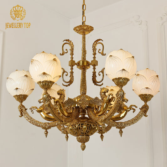 A luxury chandelier installed in a grand residence hallway with classic wall paneling and a decorative archway.