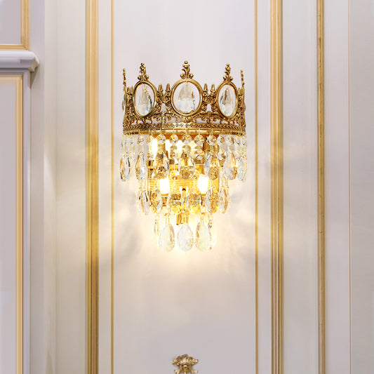 JEWELLERY TOP branded close-up of the crown wall light, highlighting the crystal-filled oval frames and brass details on white.