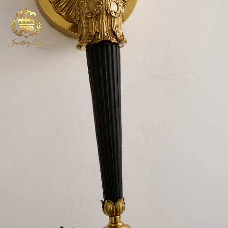 Explore exquisite craftsmanship by Jewellery Top. This detail highlights the contrasting dark bronze fluted tail of our Victorian brass wall sconce.