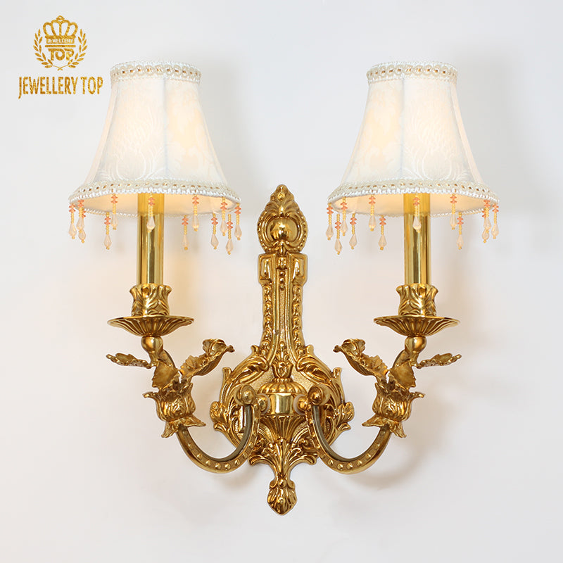 JEWELLERY TOP branded product shot of the ornate two-light sconce with bird motif and lace-trimmed shades.