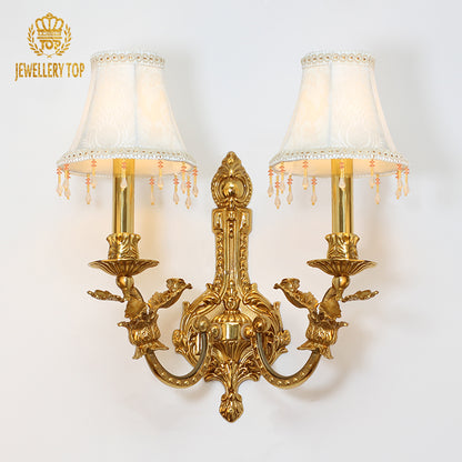 JEWELLERY TOP branded product shot of the ornate two-light sconce with bird motif and lace-trimmed shades.