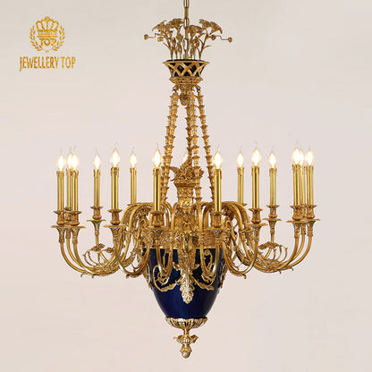 JEWELLERY TOP's brass chandelier with blue ceramic detail against a beige wall.