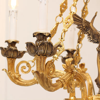 Extreme close-up of ornate brass lotus base, phoenix detail, and candle bulb on chandelier arm.