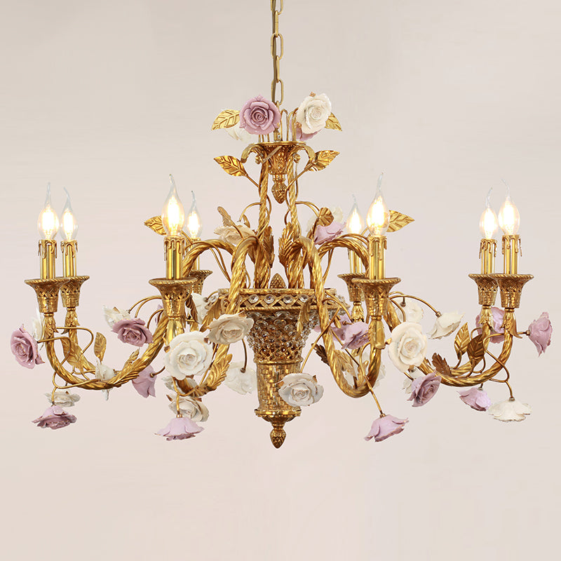 French-style brass dining room chandelier with purple and white ceramic flowers and crystal accents.
