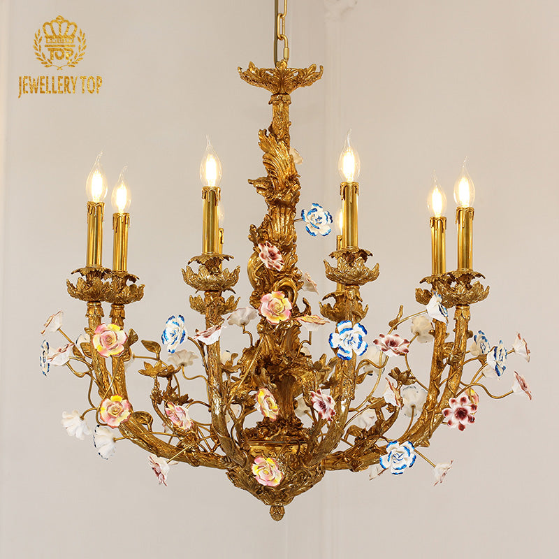 Front view of JEWELLERY TOP's golden brass chandelier decorated with pink and blue porcelain blooms.