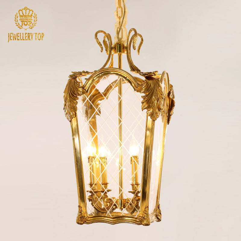Close-up front view of the JEWELLERY TOP brand's rectangular brass pendant light with glass panels.