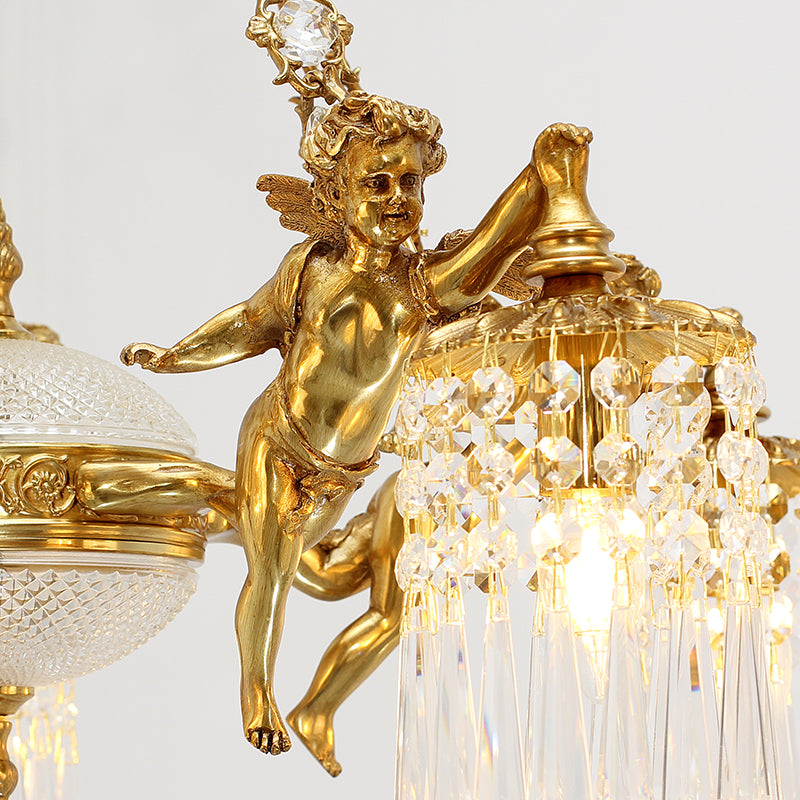Extreme detailed macro of a sculpted brass cherub figurine holding a crystal element on the chandelier.