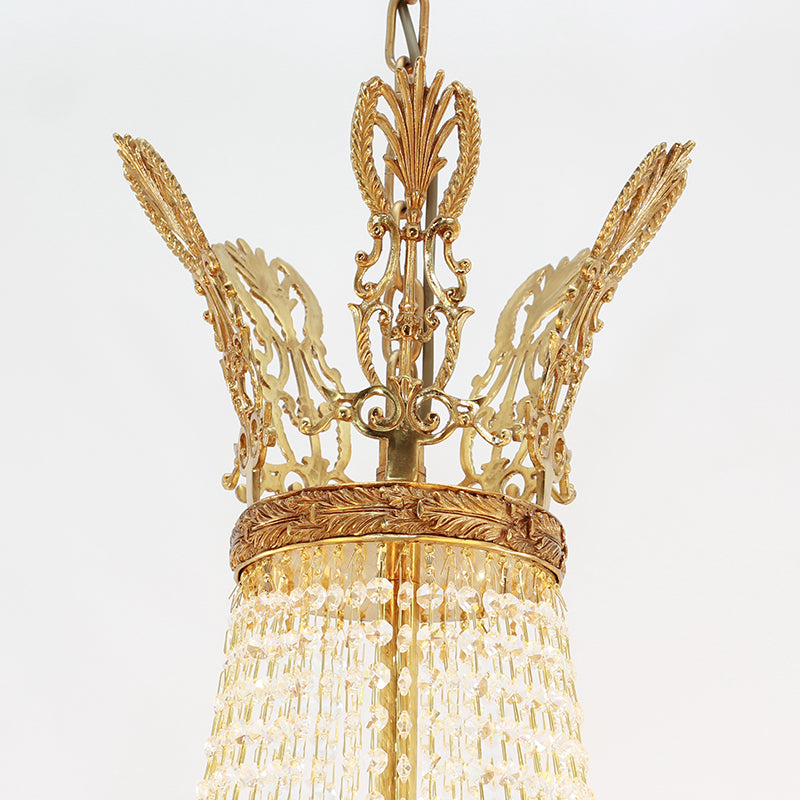 Detailed top view of a French brass chandelier's intricate coronet-shaped canopy and chains.