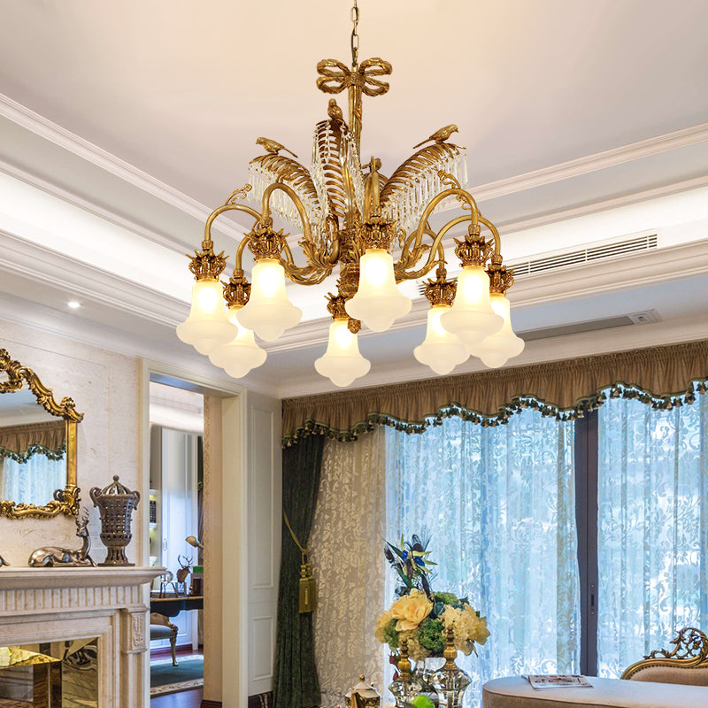 French brass chandelier with crystal accents installed in a formal living room with high ceilings.