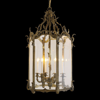 French lantern brass pendant light with “Eve” text, showcasing candle bulbs and glass.