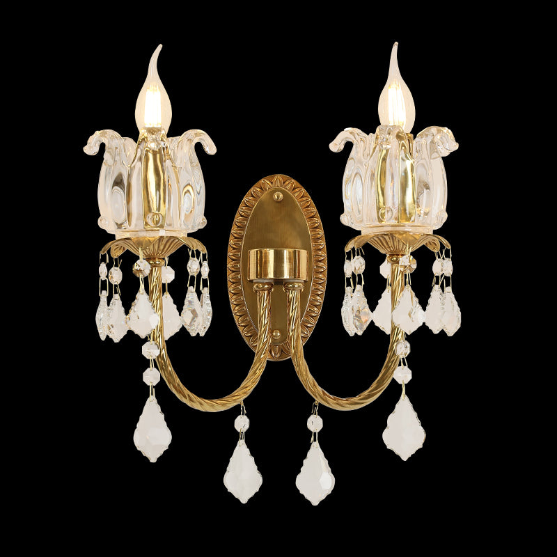 Tulipe Royale golden brass double wall sconce with tulip glass shades and crystal drops, installed on a light wall.