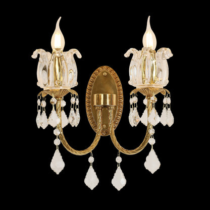 Tulipe Royale golden brass double wall sconce with tulip glass shades and crystal drops, installed on a light wall.