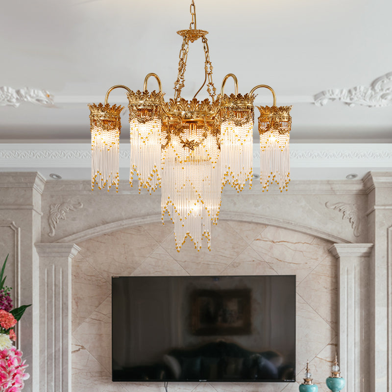A luxury european chandelier installed above a grand marble fireplace, showcasing its opulent form.