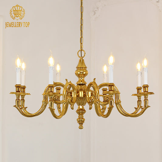 A luxury decorative chandelier installed in a formal dining room with a dark wood table and classic paneled walls.
