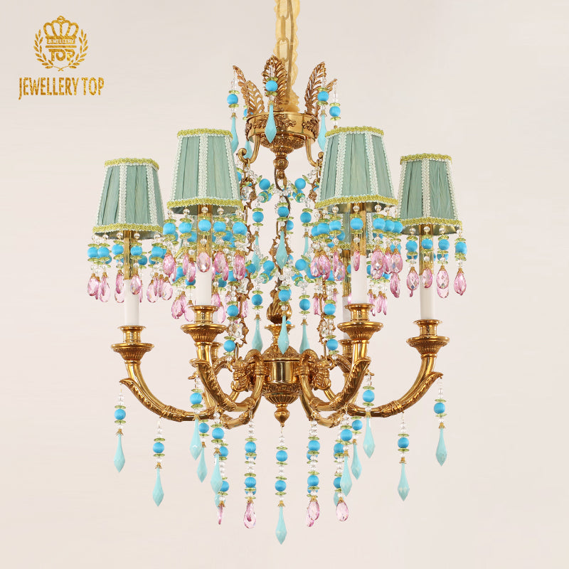 Detailed view of a JEWELLERY TOP brass chandelier with mint green shades and colored crystals.