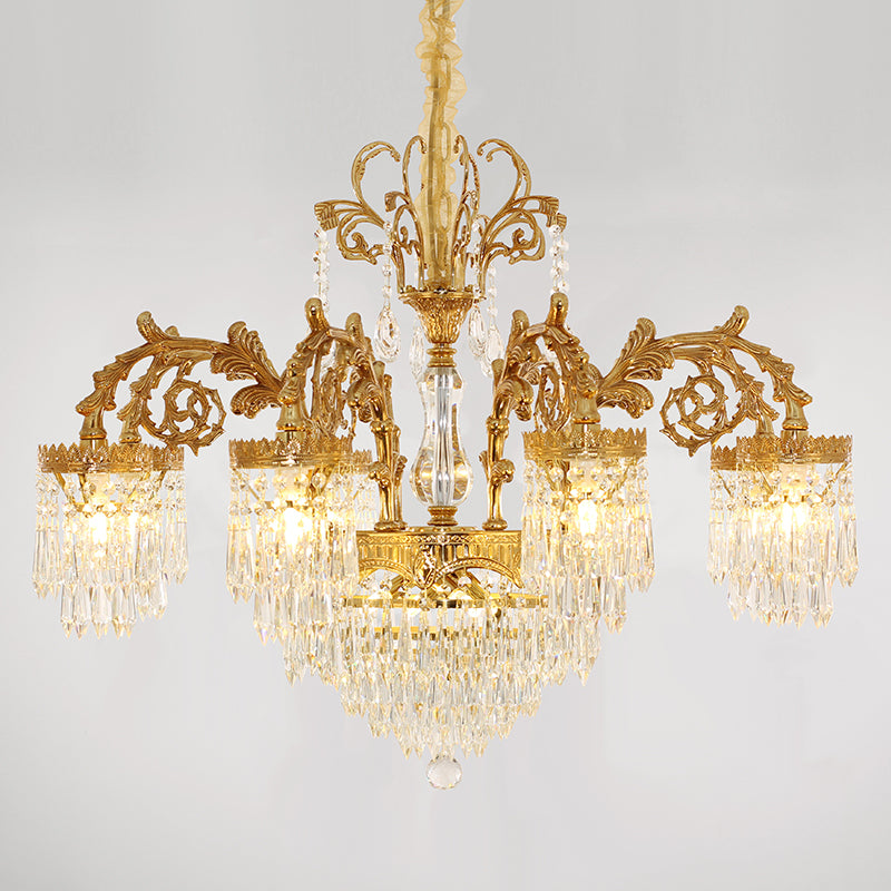 Golden vintage chandelier with multiple arms and crystal decorations, white background.