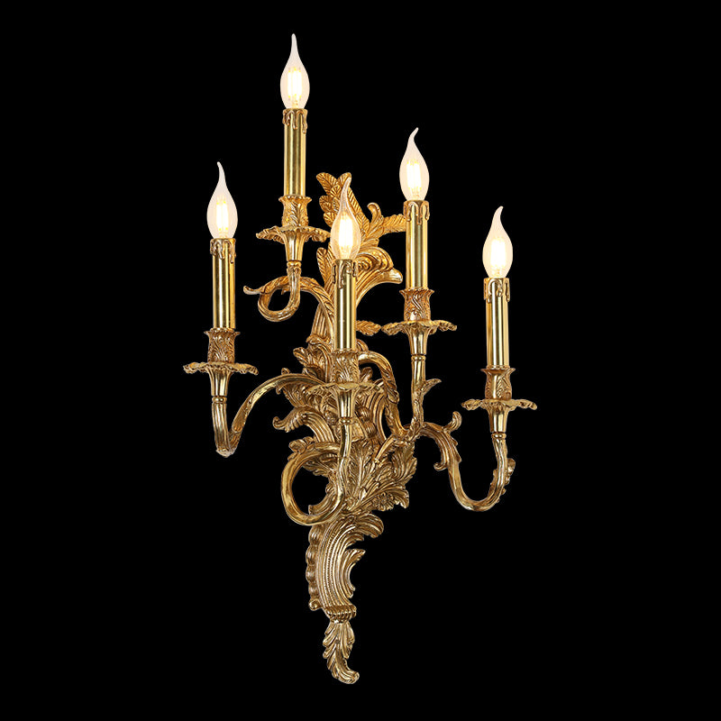 Front view of the five-arm Victorian Gala golden brass candelabra wall sconce with lit candle bulbs on black.