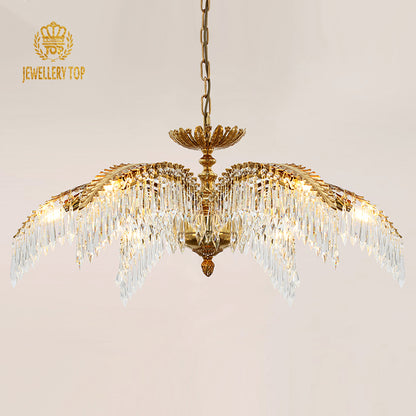 Close-up front view of the golden palm frond and crystal droplet details on the brass chandelier.