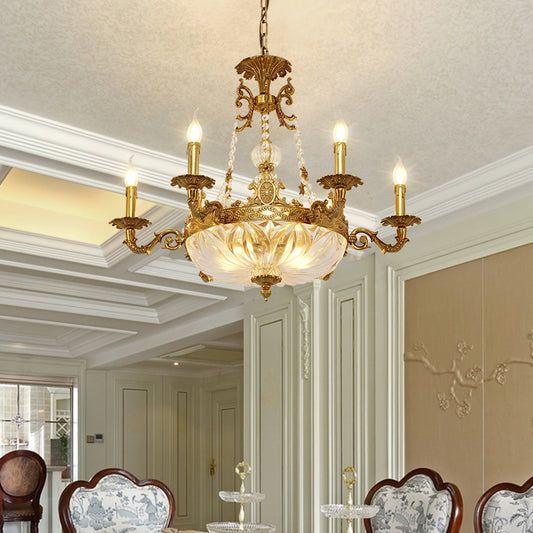 The vintage French brass chandelier installed in a living room with a window and patterned chair.